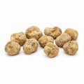Medium-size fresh Tuber magnatum white truffles with pale ochre surfaces and natural shape variation