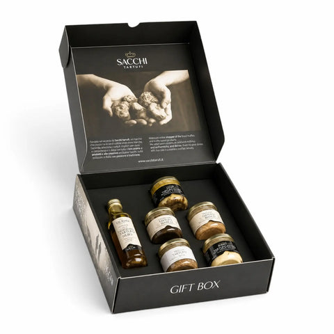 Geöffnete Desirée Premium-Trüffel-Geschenkbox mit Olivenöl mit weißem Trüffelaroma, Sommertrüffelsauce, Trüffelbutter und drei herzhaften Cremes